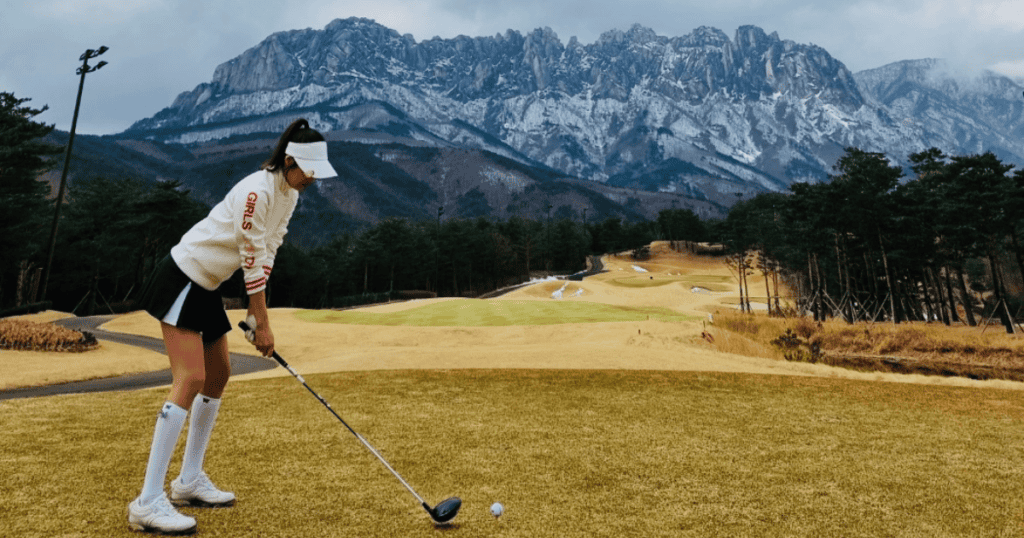 Preparing for a tee shot on the IN Course at Sonofelice CC Del Pino with Ulsanbawi Rock as the backdrop.
