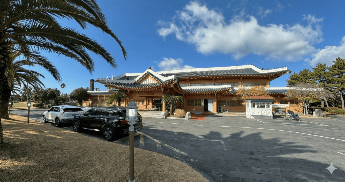 Scenic view of Jungmun Golf Club in Jeju during winter with green fairways and ocean background
