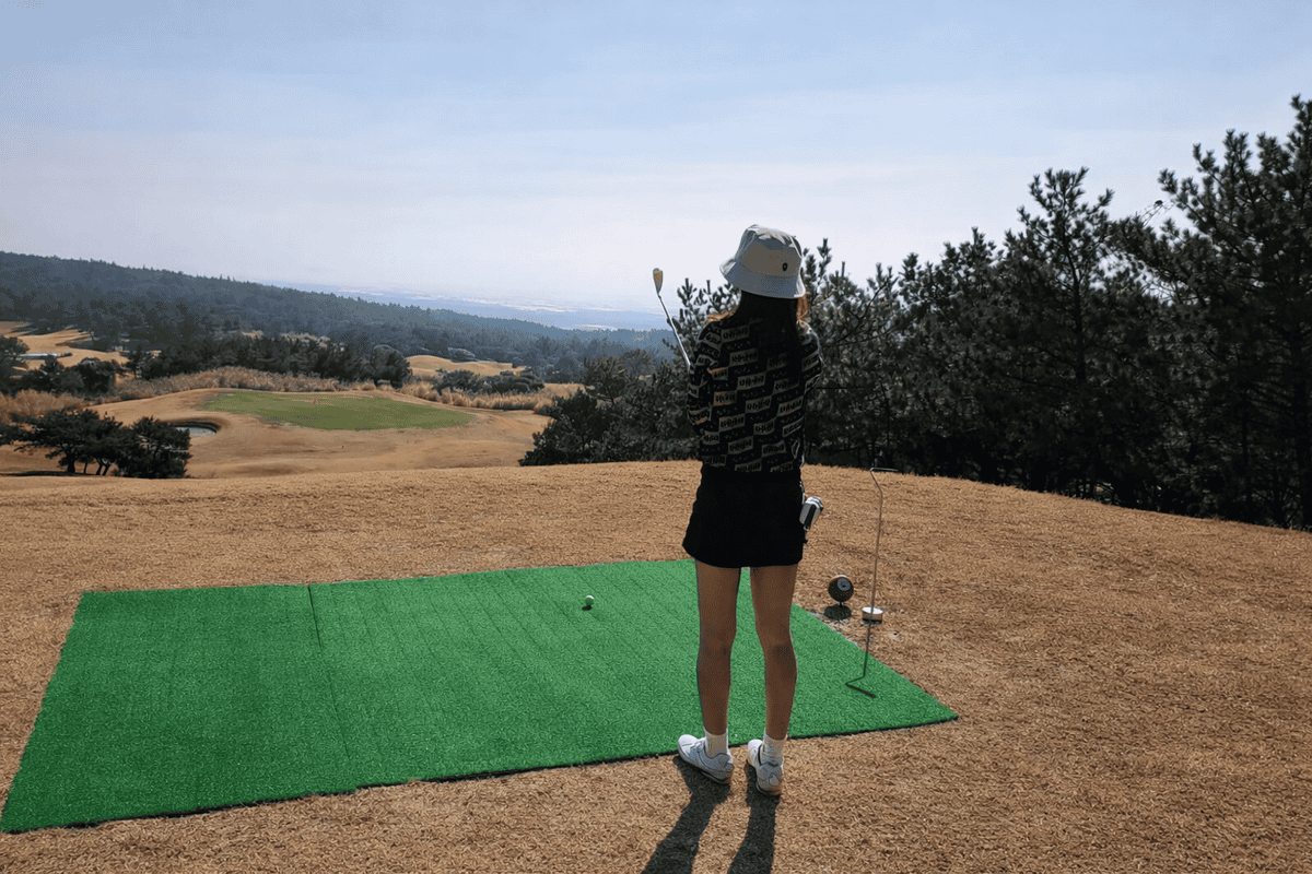 Winter golf round at Volcano CC Jeju with panoramic course and ocean view from the tee box