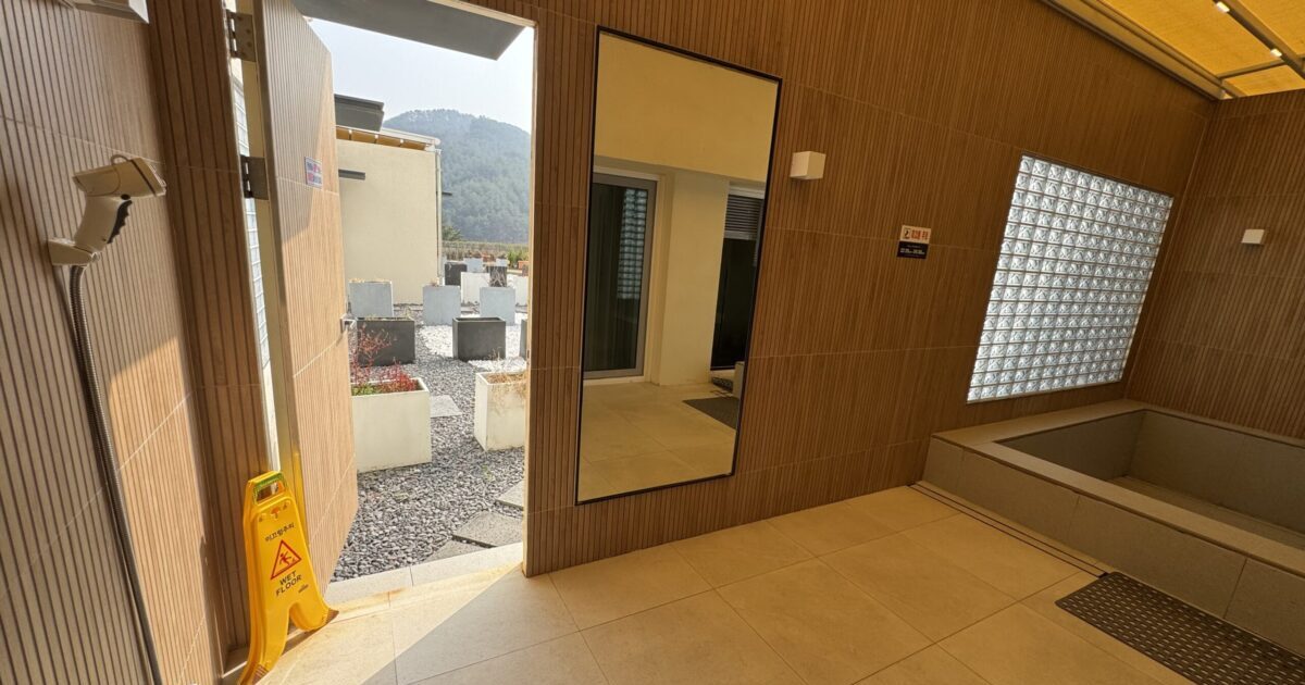 Private open-air Terrace Spa bath at Deokgu Hot Springs Hotel, Uljin, with a large bathtub and retractable ceiling